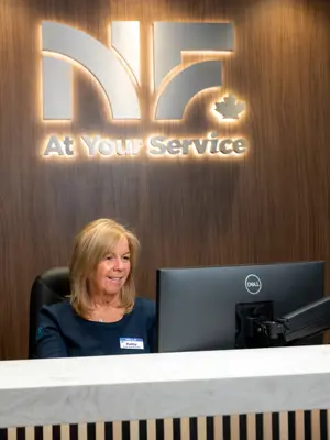 City of Niagara Falls customer service representative seated at the front service counter of City Hall, ready to serve customers.