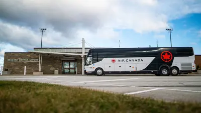Air Canada luxury motorcoach bus in front of the Niagara District Airport.