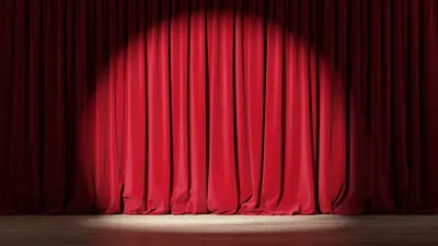 Empty stage with red velvet curtains with spotlight