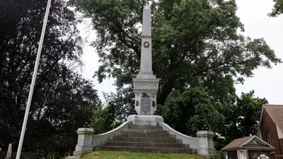 Stone soldiers monument in Drummond Hill Cemetery. Elevated on a small grassy hill.
