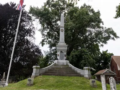 Stone soldiers monument in Drummond Hill Cemetery. Elevated on a small grassy hill.