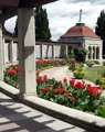 Oakes Garden with green landscaping and red flowers.