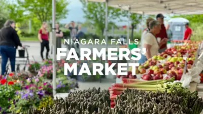 People browsing fruits and vegetables at the Niagara Falls Farmers' Market.