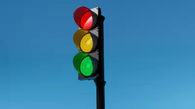 Traffic signal against a blue sky