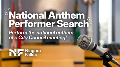 White text and City logo in front of a background photo of the Niagara Falls City Council chambers, showing a microphone. The text reads "National Anthem Performer Search". "Perform the national anthem at a City Council meeting!" 