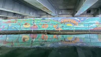 Colourful "Welcome to Chippawa" mural painted on the Weightman Bridge underpass. Showing water activities on the river.