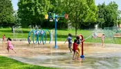 City of Niagara Falls outdoor splashpad with children playing on a bright sunny day.