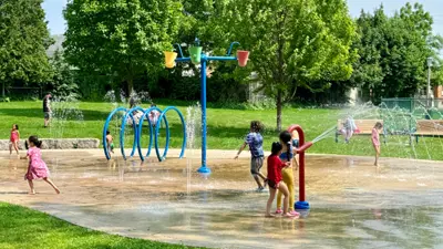 City of Niagara Falls outdoor splashpad with children playing on a bright sunny day.